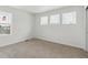 Carpeted bedroom featuring multiple windows, neutral walls, and ample natural light at 8295 Snake River St, Littleton, CO 80125