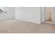 A spacious bedroom with neutral carpet, white walls, and a view from the window to the neighborhood at 8295 Snake River St, Littleton, CO 80125