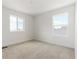 A well lit carpeted bedroom with natural lighting at 8295 Snake River St, Littleton, CO 80125