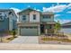 Charming two-story home boasts a well-manicured front yard, stone accents, and a welcoming front porch at 8295 Snake River St, Littleton, CO 80125