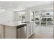 Bright kitchen with stainless steel appliances, white cabinets and an island with quartz countertops at 8295 Snake River St, Littleton, CO 80125