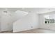 Bright living room featuring a white door, staircase, a large window, and wood flooring at 8295 Snake River St, Littleton, CO 80125