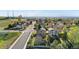 Wide aerial view of a residential street with mature trees, power lines, and nearby greenery at 21851 Omaha Ave, Parker, CO 80138