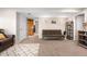 Basement area includes a futon couch with carpet flooring and additional room space at 21851 Omaha Ave, Parker, CO 80138