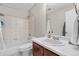 Cozy bathroom features a bathtub and shower combination with tiled walls and a single sink vanity at 21851 Omaha Ave, Parker, CO 80138