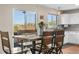 Charming dining area with a view to the balcony, featuring a rustic wooden table and chairs at 21851 Omaha Ave, Parker, CO 80138