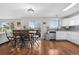 Open dining area with hardwood floors and a sliding glass door leading to the outdoor patio at 21851 Omaha Ave, Parker, CO 80138