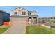 Inviting two-story house featuring a covered porch, a well-maintained lawn, and an attached two-car garage at 21851 Omaha Ave, Parker, CO 80138