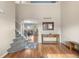 Welcoming foyer with hardwood floors, stairs, and a view into the dining area and kitchen at 21851 Omaha Ave, Parker, CO 80138