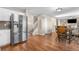 Dining Area leading to kitchen with stainless steel appliances, light cabinets, and an open staircase at 21851 Omaha Ave, Parker, CO 80138