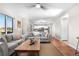 Open living space featuring a large window, hardwood floors, and comfortable gray sofas at 21851 Omaha Ave, Parker, CO 80138