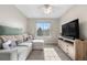 Relaxing living room with plush sofa, a ceiling fan, and large window at 21851 Omaha Ave, Parker, CO 80138
