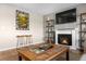 Comfortable living room with a fireplace, TV, and decorative shelving, perfect for cozy evenings at 21851 Omaha Ave, Parker, CO 80138