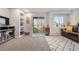 Open living area with built-in shelving, sliding door access to the yard, and a cozy seating area at 21851 Omaha Ave, Parker, CO 80138