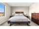 Serene bedroom with a large window, dark wood furniture, and comfortable bedding at 21851 Omaha Ave, Parker, CO 80138