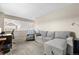 Comfortable office space featuring a gray sectional couch, desk and window at 21851 Omaha Ave, Parker, CO 80138
