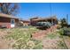 Spacious backyard featuring a covered patio, brick accents, and lush landscaping at 6305 Yukon St, Arvada, CO 80004