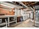 Unfinished basement with workbench, laundry area, and exposed ceiling offers potential for customization at 6305 Yukon St, Arvada, CO 80004