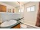 Bathroom featuring retro finishes with neutral white walls and a green counter top at 6305 Yukon St, Arvada, CO 80004