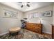 Bedroom featuring light-colored walls, a ceiling fan, and decoratively patterned windows for visual appeal at 6305 Yukon St, Arvada, CO 80004