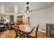 Traditional dining room featuring hardwood floors and decorative lighting at 6305 Yukon St, Arvada, CO 80004