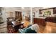 Open-concept living space featuring wood flooring and seamless flow to the kitchen at 6305 Yukon St, Arvada, CO 80004