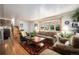 Comfortable living room featuring wood floors and bright windows at 6305 Yukon St, Arvada, CO 80004