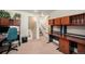 Home office with built in desk, overhead cabinets, and an adjacent staircase at 6305 Yukon St, Arvada, CO 80004