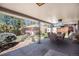 Covered patio with outdoor dining set overlooks the landscaped backyard and detached garage at 6305 Yukon St, Arvada, CO 80004