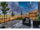 Backyard patio with outdoor furniture and view of the open field, perfect for relaxing at 6309 N Hanover St, Denver, CO 80238
