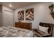 Bedroom showcasing a dresser with decorative art and chair, enhancing the room's aesthetic at 6309 N Hanover St, Denver, CO 80238