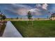 Central community green with young trees, bench seating, and surrounding new homes at 6309 N Hanover St, Denver, CO 80238