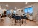 Bright dining area with a round table, seating for four, and hardwood floors, perfect for casual meals and gatherings at 6309 N Hanover St, Denver, CO 80238