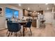 Cozy dining area with an adjacent kitchen, featuring wood cabinets and an island with bar seating, ideal for everyday living at 6309 N Hanover St, Denver, CO 80238