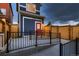 Charming two-story home showcasing a vibrant red front door and low-maintenance black metal railing at 6309 N Hanover St, Denver, CO 80238