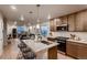 Bright, modern kitchen with stainless steel appliances and island open to living spaces at 6309 N Hanover St, Denver, CO 80238