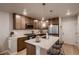 Modern kitchen features stainless steel appliances, ample cabinet space, and a center island with bar seating at 6309 N Hanover St, Denver, CO 80238
