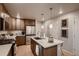 Well-lit kitchen boasts stainless appliances, quartz countertops, and functional island with sink and dishwasher at 6309 N Hanover St, Denver, CO 80238