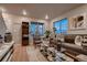 Well-lit living room with hardwood floors, stylish furniture, and large windows, perfect for relaxing and entertaining at 6309 N Hanover St, Denver, CO 80238