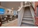 Bright living room featuring a staircase, modern decor, and natural light, creating an inviting space at 6309 N Hanover St, Denver, CO 80238