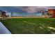 The lush green park, dotted with young trees, extends towards the horizon at 6309 N Hanover St, Denver, CO 80238