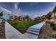 A picturesque neighborhood green space is surrounded by charming homes with colorful exteriors and well-manicured lawns at 6309 N Hanover St, Denver, CO 80238