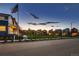 Street view showing a row of new colorful homes surrounding a central community green at 6309 N Hanover St, Denver, CO 80238
