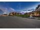 Charming neighborhood street featuring well-maintained homes and lush green spaces under a picturesque sky at twilight at 6309 N Hanover St, Denver, CO 80238