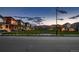 Street view of neighborhood featuring well-maintained homes and lush green spaces under a picturesque sky at twilight at 6309 N Hanover St, Denver, CO 80238