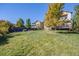 Large grassy backyard with mature trees at 10730 Pinewalk Way, Highlands Ranch, CO 80130