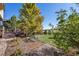 Landscaped backyard with a bench and open space at 10730 Pinewalk Way, Highlands Ranch, CO 80130