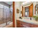 Bathroom with a walk-in shower and double sink vanity at 10730 Pinewalk Way, Highlands Ranch, CO 80130