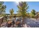 Deck with table and chairs, offering scenic views at 10730 Pinewalk Way, Highlands Ranch, CO 80130