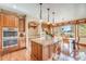 Kitchen with an island, stainless steel appliances, and hardwood floors at 10730 Pinewalk Way, Highlands Ranch, CO 80130